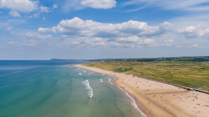 Aerial view on sandy Beach and coast of Atlantic Ocean in Portrush Northern Ireland, Top view on small coastal town 
