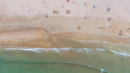 Aerial view on sandy Beach and coast of Atlantic Ocean in Portrush Northern Ireland, Top view on small coastal town 