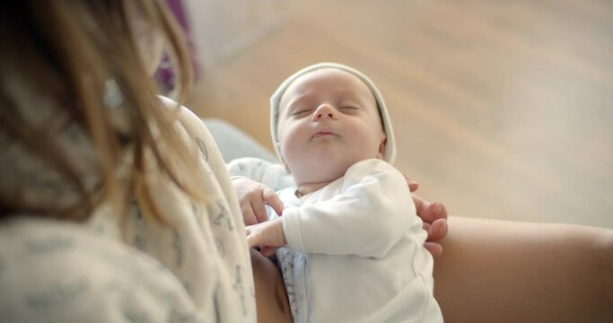 Mommy breastfeeding newborn baby boy lying her hands. Baby eating mother's milk. Young woman nursing and feeding baby. Concept of lactation infant