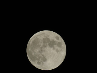 An amazing photography of the full moon over the city of Genova by night with a great clear sky in background and some stars