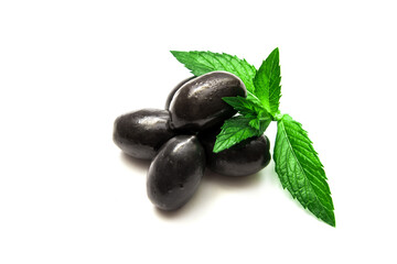 Black olives with mint leaves on a white background