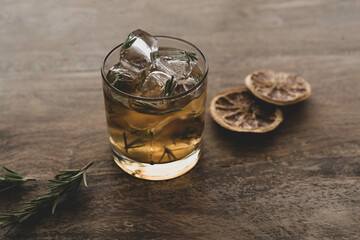 Rosemary and Orange Ice Tea on wooden background. Summer food and drink.