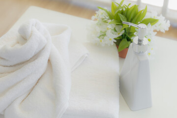 Shampoo and shower cream bottle with towel