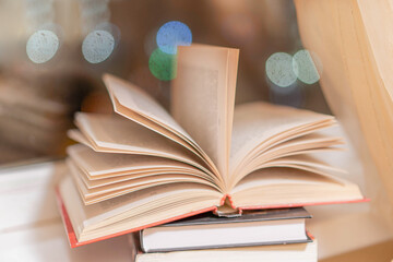 An interesting book is lying by the window for evening reading