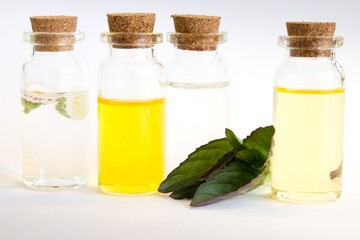 Beautiful photo of small bottles with cork stoppers filled with fantastic fragrant oil, essential...