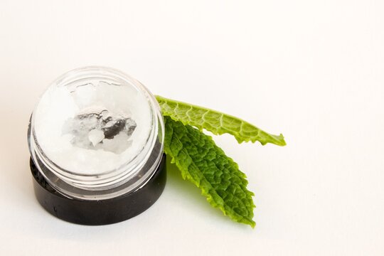 Beautiful photo of small bottle, gallipot with aloe vera gel and peppermint