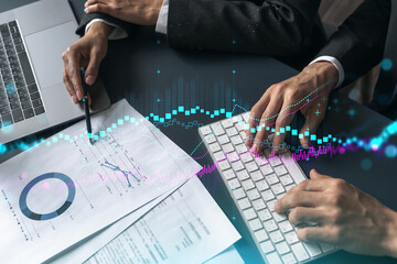 Two business people working together on stock market strategy. Try to analyze forex behavior....