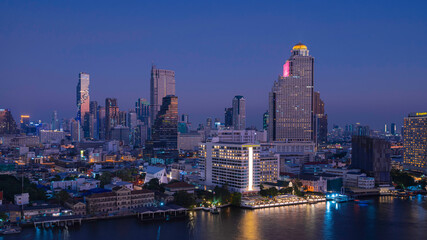 Fototapeta na wymiar Aerial and panorama view of Bangkok skyscraper cityscape and river in twilight blue hour