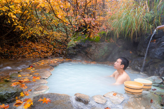 Young Man Soak In Outdoor Onsen Hot Spring In Autumn 