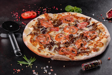 Fresh hot pizza with meat, mushrooms, cheese and tomatoes made in an oven