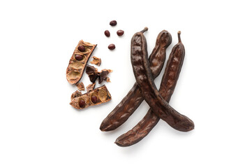 Isolated open carob pods with grains. Top view. 