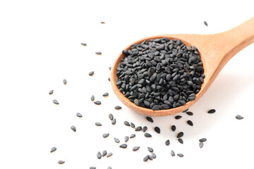 Black sesame seeds on wood spoon isolated on white background.