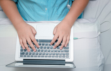 Fototapeta na wymiar child working homework with laptop on bed.