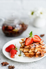 Delicious fresh baked belgian waffles with berries and fruit