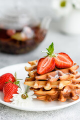 Delicious fresh baked belgian waffles with berries and fruit