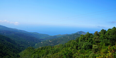 mountain landscape with clouds and blue sea