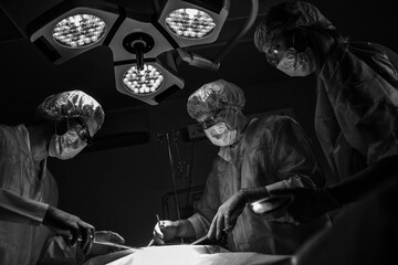 Team of Professional Surgeons and Nurses Suture Wound after Successful Surgery.