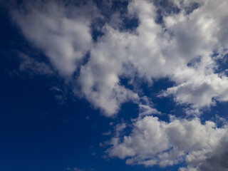 Fototapeta premium White fluffy clouds in the blue sky. Summer, cloudy. The air, the atmosphere.
