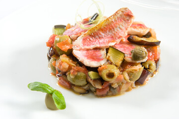 red mullet and caponata typical side dish of Sicily prepared with aubergines in a white background