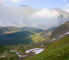 green mountain valley in a dense clouds