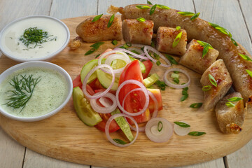 Baked sausages with spring salad