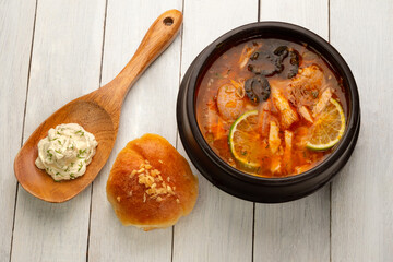 soup hodgepodge in a deep plate on a light wooden table