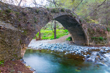 Fototapeta na wymiar old medieval stony bridge over the small river