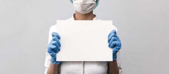 Doctor holding a blank board. Place for inscription. Close-up photo