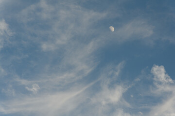 moon and clouds during daylight