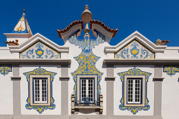 ancient aristocratic villa with facades decorated with yellow and blue azulejos in Cascais, Portugal