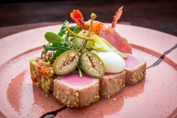 beautiful food: steak tuna in sesame, lime and fresh salad close-up on a plate