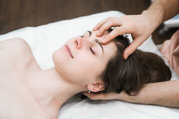 Fototapeta na wymiar male masseur makes girl Thai head massage 7