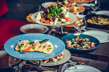 many different dishes in Restaurant, white plate on the Table with side dish,