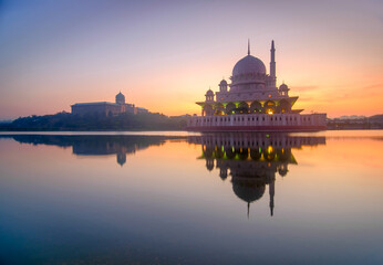 Beautiful sunrise in putrajaya malaysia with reflection in lake water with mosque in visibility. Putrajaya in administrative capital of malaysia. Selective focus.