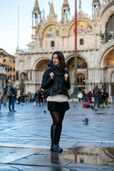 Fototapeta premium vertical of a cute european tourist girl in Piazza San Marco