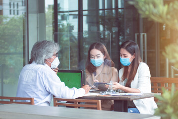 Group of people wearing masks and working together