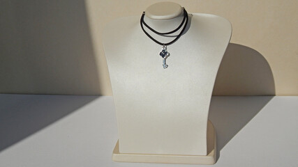                         black leather necklace with key pendant       