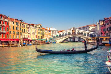 Fototapeta na wymiar Gondola on Grand canal near Rialto bridgein Venice, Italy