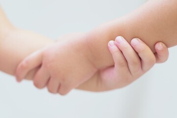 Blurred Close up of kid boy and girl Holding Hands