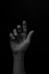 Male black hand gesture isolated on black background