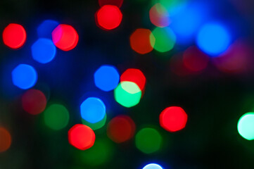 Blurry Christmas lights out of focus background. Christmas texture for decoration and graphic design for the Christmas.
