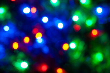 Holiday bokeh. Abstract Christmas background. Blurred multicolored garland.