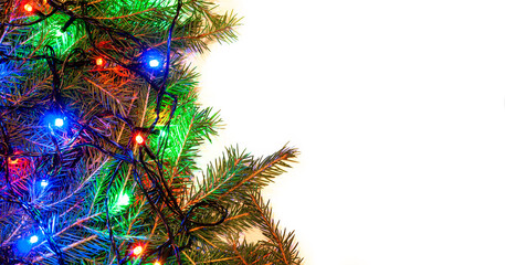 Christmas white background with spruce branches and colorful garlands on the side of the frame. Design template for Happy New Year and Marry Christmas.