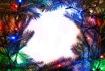 Christmas background with spruce branches and colorful garlands. Design template for Happy New Year and Marry Christmas.