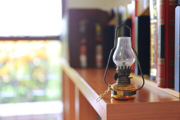 Close-up of a small antique lamp on the library bookshelf selective focus and shallow depth of field