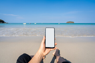 Young asian man traveler using smartphone at tropical sand beach, Summer vacation concept
