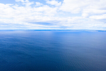 Obraz premium Aerial view of a crystal clear sea water texture. View from above Natural blue background. Blue water reflection. Blue ocean wave. Summer sea. Drone. Top view