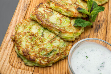 Pancakes with zucchini with white sauce