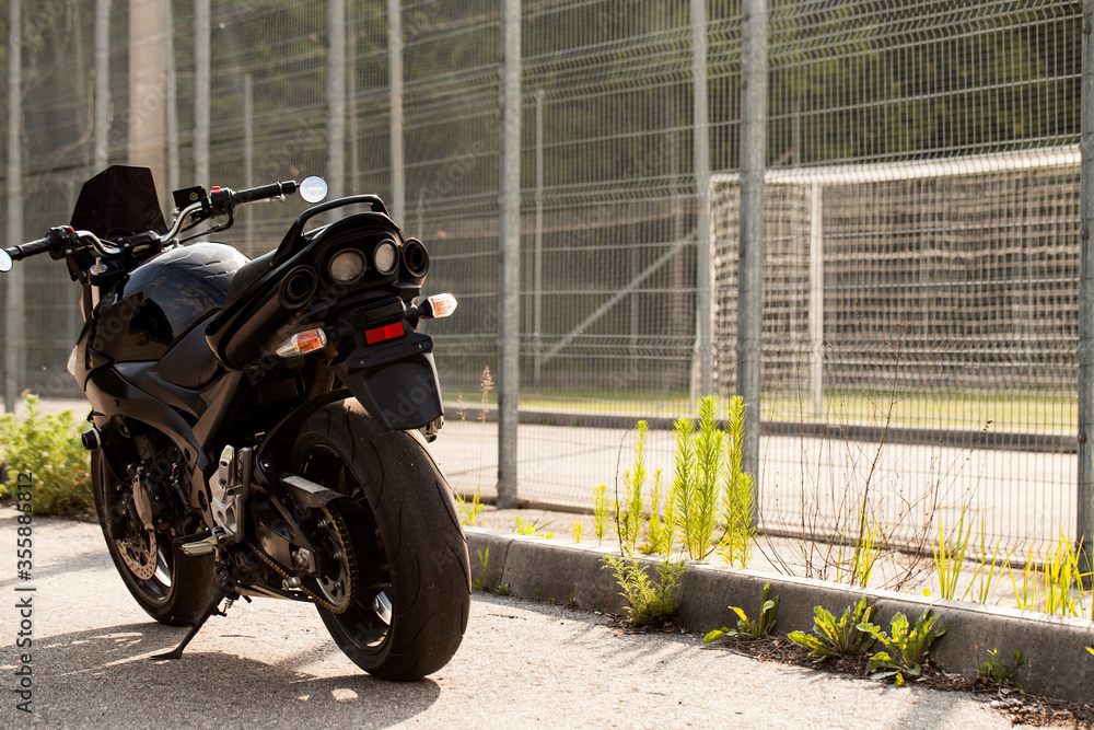 Wall mural Road black motorcycle on the road.