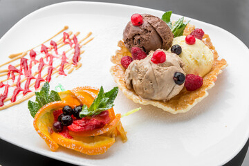 Ice cream sundae, waffle cone and sliced strawberry